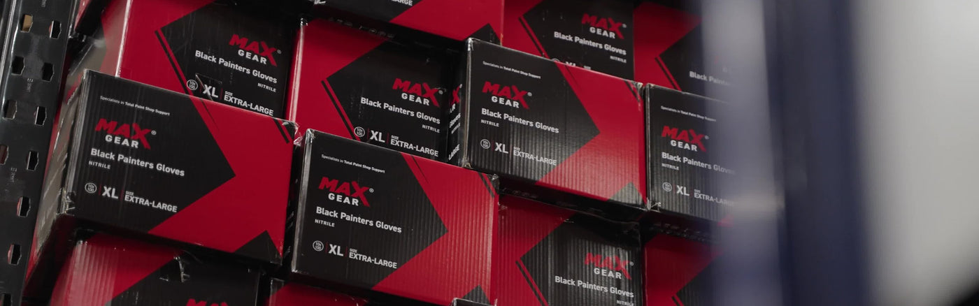 Boxes stacked in warehouse containing Black Painters Gloves